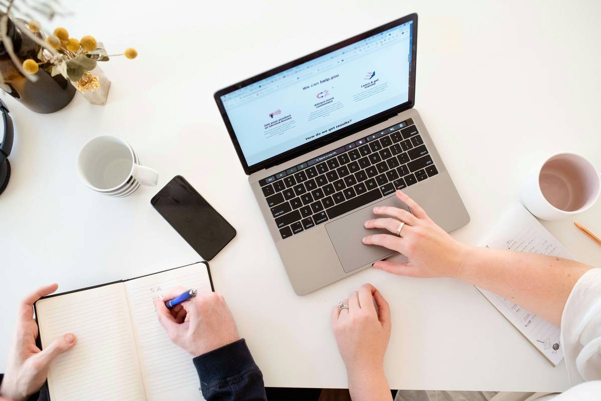 Modern workspace with MacBook Pro, iPhone and notebook